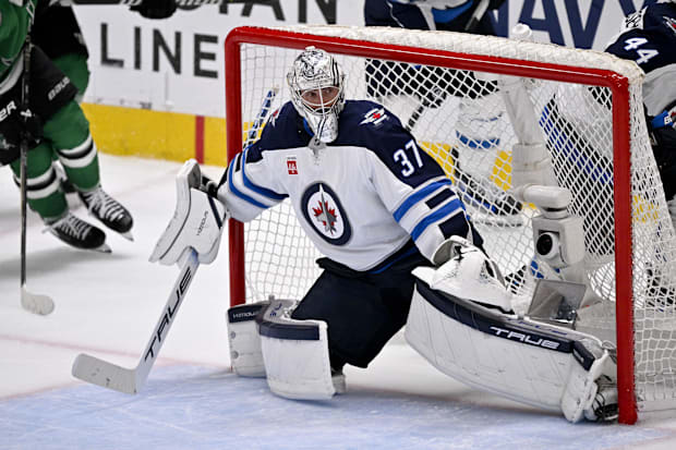 Hockey goalie in white uniform