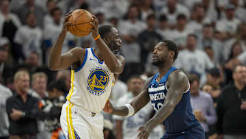 May 14, 2025; Minneapolis, Minnesota, USA; Golden State Warriors forward Draymond Green (23) holds the ball up as Minnesota Timberwolves forward Julius Randle (30) plays defense in the first half during game five of the second round for the 2025 NBA Playoffs at Target Center. Mandatory Credit: Jesse Johnson-Imagn Images