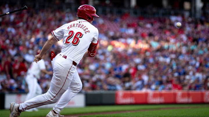 Cincinnati Reds outfielder Jacob Hurtubise (26) runs to first after hitting a sacrifice bunt advancing runners to second and third in the second inning of the MLB game between the Cincinnati Reds and the Chicago Cubs at Great American Ball Park in Cincinnati on Thursday, June 6, 2024.