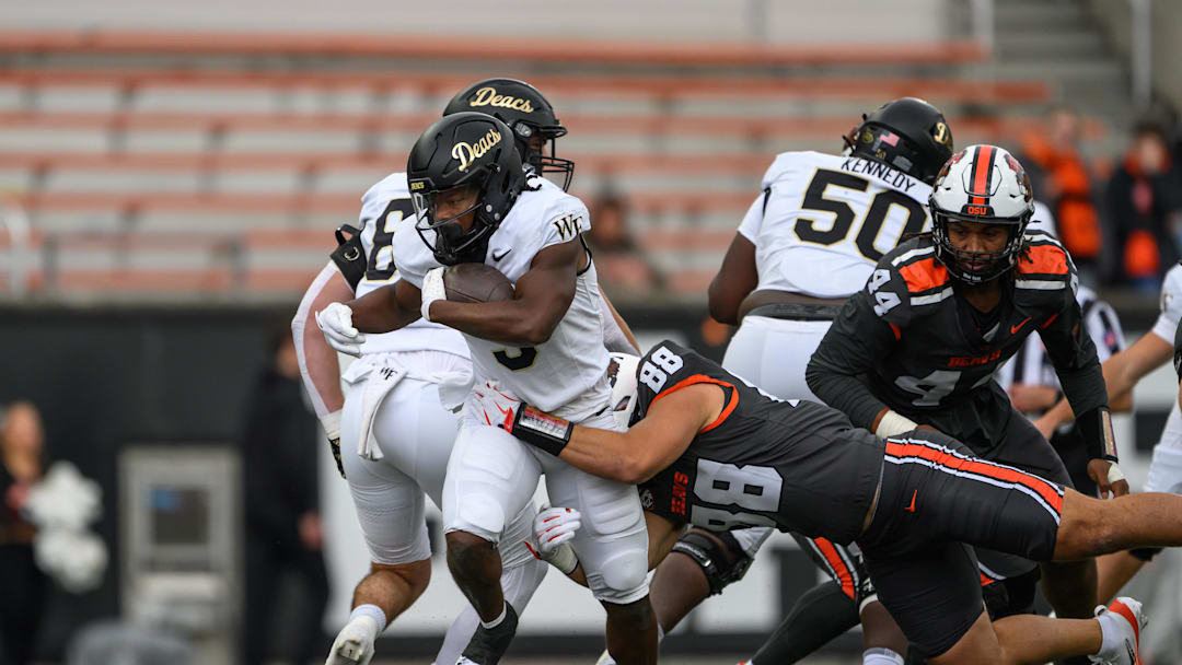 Oct 11, 2025; Corvallis, Oregon, USA; Wake Forest Demon Deacons running back Jamario Clements (3) runs the ball and is tackled by Oregon State Beavers linebacker Andy Alfieri (88) during the second half at Reser Stadium. Mandatory Credit: Craig Strobeck-Imagn Images