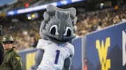 Oct 25, 2025; Morgantown, West Virginia, USA; The Texas Christian University Horned Frogs mascot celebrates along the sidelines during the first quarter against the West Virginia Mountaineers at Milan Puskar Stadium. Mandatory Credit: Ben Queen-Imagn Images