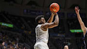 Feb 11, 2025; Morgantown, West Virginia, USA; West Virginia Mountaineers guard Joseph Yesufu (1) shoots during the first half against the Brigham Young Cougars at WVU Coliseum. Mandatory Credit: Ben Queen-Imagn Images