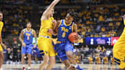 Nov 13, 2025; Morgantown, West Virginia, USA; Pittsburgh Panthers guard Omari Witherspoon (8) drives against West Virginia Mountaineers guard Treysen Eaglestaff (52) during the first half at WVU Coliseum. Mandatory Credit: Ben Queen-Imagn Images