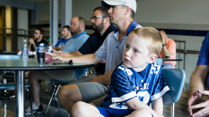 Marty McCord, wearing a Jared Lorenzen jersey, watches Matt Jones perform a special radio show in honor of Jared Lorenzen in front of a live audience at Highlands Athletics in Fort Thomas, Ky., on Thursday, July 11, 2019.  Kentucky Sports Radio host Matt Jones and started a fund to help support Jared Lorenzen's family.

Kentucky Sports Radio Jared Lorenzen
