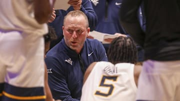 Feb 11, 2025; Morgantown, West Virginia, USA; West Virginia Mountaineers head coach Darian DeVries talks to his team during the second half against the Brigham Young Cougars at WVU Coliseum. Mandatory Credit: Ben Queen-Imagn Images
