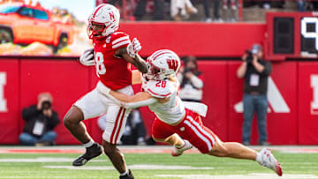 Nov 23, 2024; Lincoln, Nebraska, USA; Nebraska Cornhuskers wide receiver Isaiah Neyor (18) runs after a catch against Wisconsin Badgers linebacker Christian Alliegro (28) during the second quarter at Memorial Stadium. Mandatory Credit: Dylan Widger-Imagn Images
