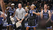Feb 11, 2025; Morgantown, West Virginia, USA; The Brigham Young Cougars bench reacts after a score late during the second half against the West Virginia Mountaineers at WVU Coliseum. Mandatory Credit: Ben Queen-Imagn Images