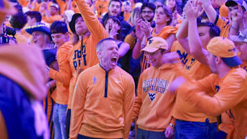 Nov 13, 2025; Morgantown, West Virginia, USA; West Virginia Mountaineers head coach Ross Hodge sings “Country Roads” with students after defeating the Pittsburgh Panthers at WVU Coliseum. Mandatory Credit: Ben Queen-Imagn Images
