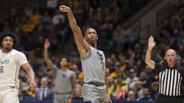 Mar 8, 2025; Morgantown, West Virginia, USA; West Virginia Mountaineers guard Javon Small (7) watches after shooting a three pointer during the first half against the UCF Knights at WVU Coliseum. Mandatory Credit: Ben Queen-Imagn Images