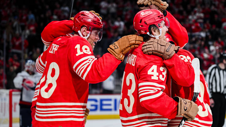 Dec 21, 2025; Detroit, Michigan, USA; Detroit Red Wings left wing John Leonard (43) celebrates with center Andrew Copp (18) and right wing Alex Debrincat (93) during the second period against the Washington Capitals at Little Caesars Arena. Mandatory Credit: Tim Fuller-Imagn Images