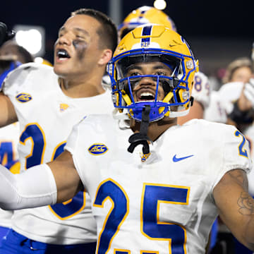 Sep 17, 2022; Kalamazoo, Michigan, USA;  Pittsburgh Panthers cornerback A.J. Woods (35) and Brandon George (30) celebrate beating the Western Michigan Broncos after the game at Waldo Stadium. Mandatory Credit: Kimberly Moss-Imagn Images