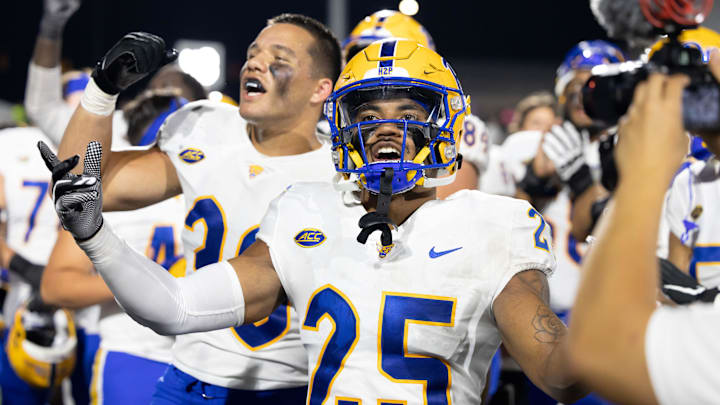 Sep 17, 2022; Kalamazoo, Michigan, USA;  Pittsburgh Panthers cornerback A.J. Woods (35) and Brandon George (30) celebrate beating the Western Michigan Broncos after the game at Waldo Stadium. Mandatory Credit: Kimberly Moss-Imagn Images