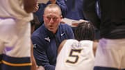 Feb 11, 2025; Morgantown, West Virginia, USA; West Virginia Mountaineers head coach Darian DeVries talks to his team during the second half against the Brigham Young Cougars at WVU Coliseum. Mandatory Credit: Ben Queen-Imagn Images