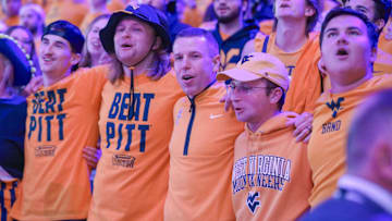 Nov 13, 2025; Morgantown, West Virginia, USA; West Virginia Mountaineers head coach Ross Hodge sings “Country Roads” with students after defeating the Pittsburgh Panthers at WVU Coliseum. Mandatory Credit: Ben Queen-Imagn Images