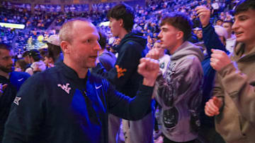 Mar 8, 2025; Morgantown, West Virginia, USA; West Virginia Mountaineers head coach Darian DeVries celebrates with fans after defeating the UCF Knights at WVU Coliseum. Mandatory Credit: Ben Queen-Imagn Images