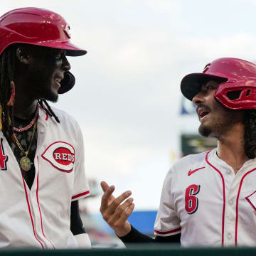 Cincinnati Reds shortstop Elly De La Cruz (44) and second base Jonathan India (6) chat as they return to the dugout after scoring on a Spencer Steer double in the fourth inning of the MLB National League game between the Cincinnati Reds and the Pittsburgh Pirates at Great American Ball Park on Monday, June 24, 2024.