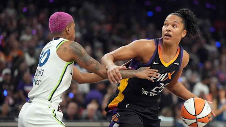 Sep 26, 2025; Phoenix, Arizona, USA; Phoenix Mercury forward Alyssa Thomas (25) drives the ball as Minnesota Lynx guard Courtney Williams (10) defends during game three of the second round for the 2025 WNBA Playoffs at PHX Arena. Mandatory Credit: Rick Scuteri-Imagn Images
