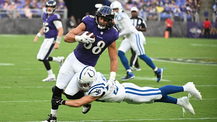 Aug 7, 2025; Baltimore, Maryland, USA; Baltimore Ravens tight end Charlie Kolar (88) is tackled by Indianapolis Colts safety Hunter Wohler (30) during the first quarter at M&T Bank Stadium.