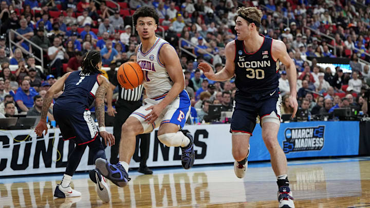 Mar 23, 2025; Raleigh, NC, USA; Florida Gators guard Walter Clayton Jr. (1) controls the ball as Connecticut Huskies forward Liam McNeeley (30) defends during the second half in the second round of the NCAA Tournament at Lenovo Center. Mandatory Credit: Bob Donnan-Imagn Images Mar 23, 2025; Raleigh, NC, USA; Florida Gators guard Walter Clayton Jr. (1) controls the ball as Connecticut Huskies forward Liam McNeeley (30) defends during the second half in the second round of the NCAA Tournament at Lenovo Center. Mandatory Credit: Bob Donnan-Imagn Images