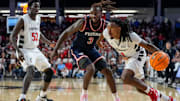 Cincinnati Bearcats guard Day Day Thomas (1) drives against Dayton Flyers forward Jaiun Simon (3) in the first half of the NCAA Men’s Basketball game between the Cincinnati Bearcats and the Dayton Flyers at Fifth Third Arena in Cincinnati on Tuesday, Nov. 11, 2025.