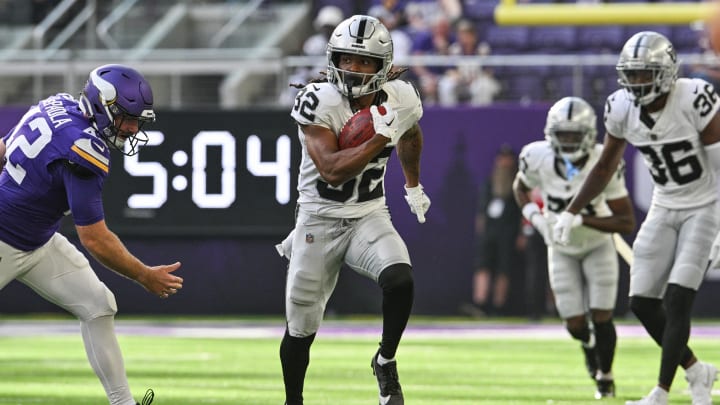 Aug 10, 2024; Minneapolis, Minnesota, USA; Las Vegas Raiders wide receiver Tyreik McAllister (32) runs the ball as Minnesota Vikings long snapper Andrew DePaola (42) chases during the third quarter at U.S. Bank Stadium. Mandatory Credit: Jeffrey Becker-USA TODAY Sports