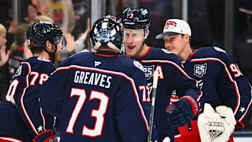 Blue Jackets goaltender Jet Greaves celebrates a win with his teammates. 