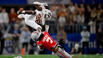 Jan 10, 2025; Arlington, TX, USA; Texas Longhorns running back Quintrevion Wisner (26) and Ohio State Buckeyes cornerback Jordan Hancock (7) in action during the game between the Texas Longhorns and the Ohio State Buckeyes