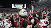 Bucky Badger crowds surfs after fans stormed the field after the Wisconsin Illinois football game Saturday, November 22, 2025, at Camp Randall Stadium in Madison, Wisconsin. Wisconsin beat Illinois 27-10.