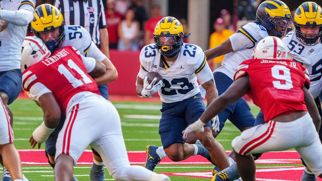 Michigan Wolverines running back Jordan Marshall (23) runs against Nebraska Cornhuskers linebacker Vincent Shavers Jr. (9) and defensive lineman Cameron Lenhardt (11) during the fourth quarter at Memorial Stadium. 