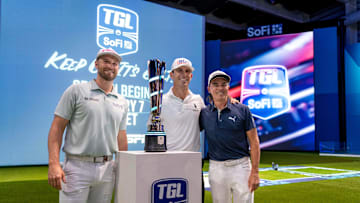 Golfers Wyndham Clark, left, Billy Horschel, center, and Rickie Fowler pose for a photo next to the TGL trophy during media day at the SoFi Center, the home of TGL, the interactive golf league founded by Tiger Woods and Rory McIlroy on December 18, 2024, in Palm Beach Gardens, Florida.