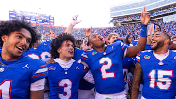 Florida Gators quarterback DJ Lagway (2) celebrates at Ben Hill Griffin Stadium with teammates Florida Gators running back Florida Gators wide receiver Aidan Mizell (11), Florida Gators wide receiver Eugene Wilson III (3) and Florida Gators linebacker Derek Wingo (15) in Gainesville, FL on Saturday, November 23, 2024. The Gators defeated the Rebels 24-17 [Doug Engle/Gainesville Sun]