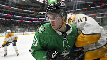 Dec 12, 2024; Dallas, Texas, USA; Dallas Stars center Oskar Back (10) and Nashville Predators right wing Michael McCarron (47) in action during the game between the Dallas Stars and the Nashville Predators at American Airlines Center. Mandatory Credit: Jerome Miron-Imagn Images