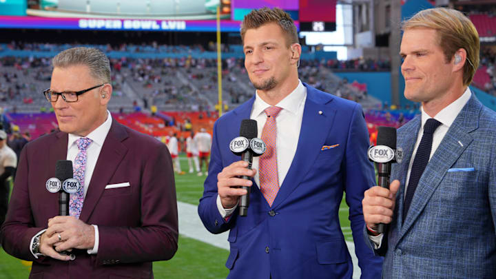 Feb 12, 2023; Glendale, Arizona, US; (Left to right) FOX Sports personalities Howie Long, Rob Gronkowski, and Greg Olsen before Super Bowl LVII at State Farm Stadium.