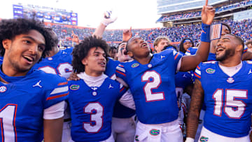 Florida Gators quarterback DJ Lagway (2) celebrates at Ben Hill Griffin Stadium with teammates Florida Gators running back Florida Gators wide receiver Aidan Mizell (11), Florida Gators wide receiver Eugene Wilson III (3) and Florida Gators linebacker Derek Wingo (15) in Gainesville, FL on Saturday, November 23, 2024. The Gators defeated the Rebels 24-17 [Doug Engle/Gainesville Sun]