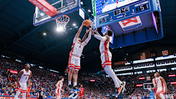 Mar 8, 2025; Lawrence, Kansas, USA; Arizona Wildcats forward Trey Townsend (4) rebounds during the second half against the Kansas Jayhawks at Allen Fieldhouse. Mandatory Credit: William Purnell-Imagn Images