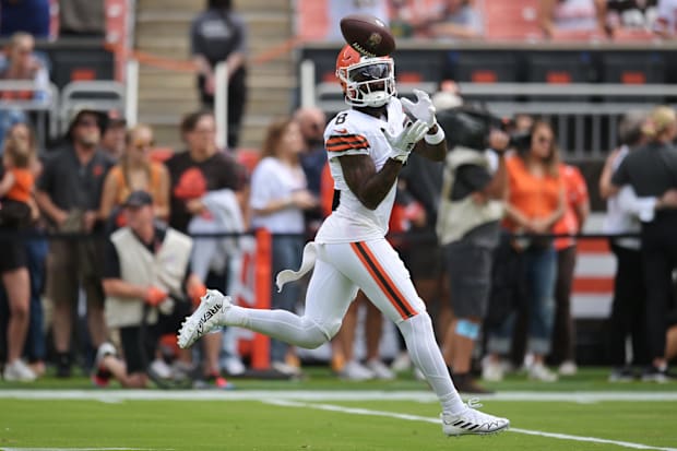 Wide receiver catches pass in warmups.