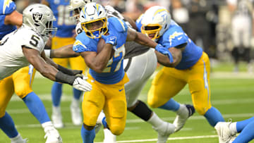 Sep 8, 2024; Inglewood, California, USA; Los Angeles Chargers running back J.K. Dobbins (27) breaks away from Las Vegas Raiders linebacker Divine Deablo (5) and runs for a touchdown in the second half at SoFi Stadium. Mandatory Credit: Jayne Kamin-Oncea-Imagn Images