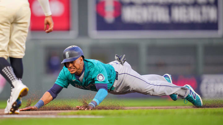 Seattle Mariners second base Jorge Polanco (7) slides into third against the Minnesota Twins in the seventh inning at Target Field on May 6.