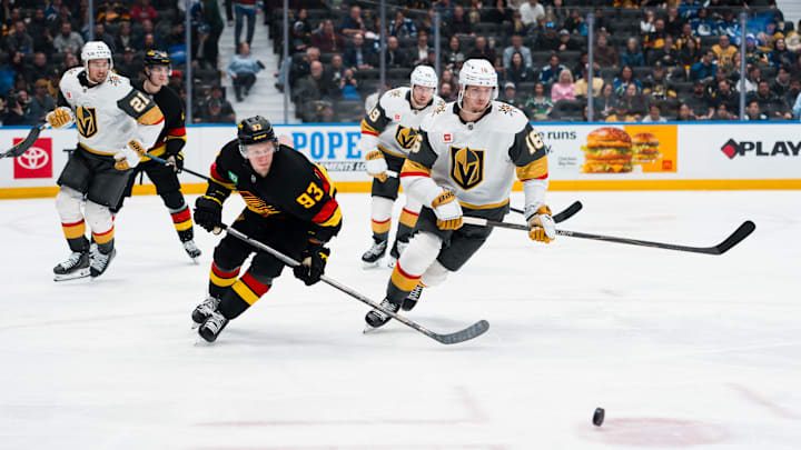 Apr 7, 2026; Vancouver, British Columbia, CAN; Vancouver Canucks forward Max Sasson (63) and Vegas Golden Knights forward Pavel Dorofeyev (16) skate after the loose puck in the third period at Rogers Arena. Mandatory Credit: Bob Frid-Imagn Images