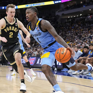 Marquette Golden Eagles guard Kam Jones (1) drives towards the basket around Purdue Boilermakers guard Fletcher Loyer (2) 