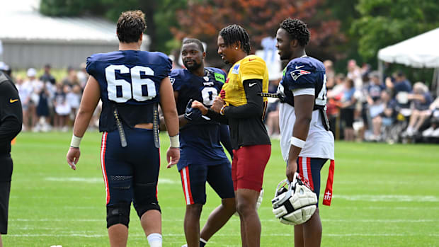 New England Patriots wide receiver Kayshon Boutte (9) shakes hands with Washington Commanders quarterback Jayden Daniels.