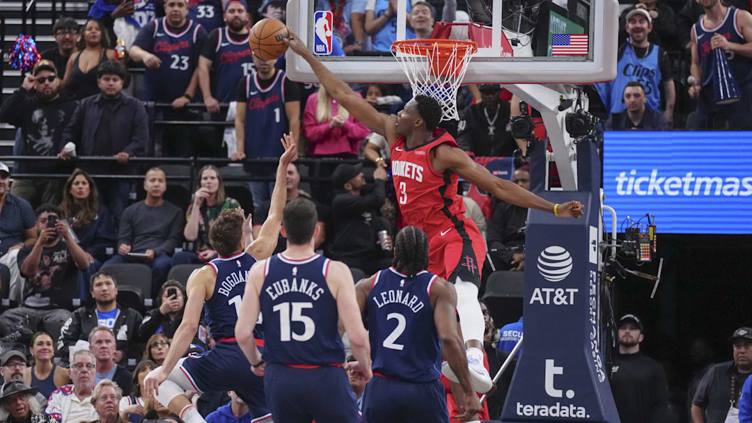 Apr 9, 2025; Inglewood, California, USA; Houston Rockets center N'Faly Dante (3) block Los Angeles Clippers guard Bogdan Bogdanovic (10) in the second half at Intuit Dome. Mandatory Credit: Kirby Lee-Imagn Images