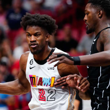 Mar 25, 2023; Miami, Florida, USA; Miami Heat forward Jimmy Butler (22) dribbles the ball past Brooklyn Nets forward Dorian Finney-Smith (28) during the second quarter at Miami-Dade Arena. Mandatory Credit: Rich Storry-USA TODAY Sports