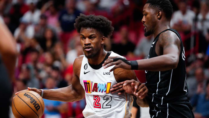 Mar 25, 2023; Miami, Florida, USA; Miami Heat forward Jimmy Butler (22) dribbles the ball past Brooklyn Nets forward Dorian Finney-Smith (28) during the second quarter at Miami-Dade Arena. Mandatory Credit: Rich Storry-USA TODAY Sports