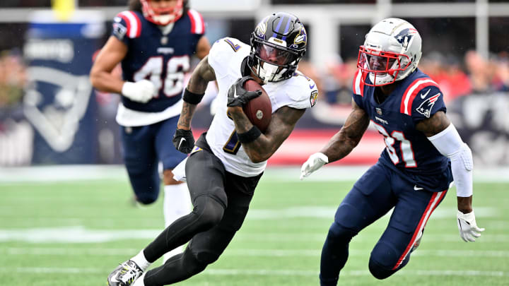 Sep 25, 2022; Foxborough, Massachusetts, USA; Baltimore Ravens wide receiver Rashod Bateman (7) runs with the ball in front of New England Patriots cornerback Jonathan Jones (31) during the second half at Gillette Stadium. Mandatory Credit: Brian Fluharty-USA TODAY Sports