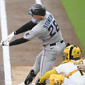 San Diego, California, USA; Miami Marlins outfielder Kyle Stowers (28) hits an RBI single during the first inning against the San Diego Padres at Petco Park.