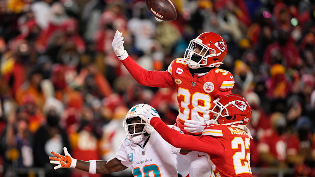 Jan 13, 2024; Kansas City, Missouri, USA; Kansas City Chiefs cornerback L'Jarius Sneed (38) and cornerback Trent McDuffie (22) break up a pass intended for Miami Dolphins wide receiver Tyreek Hill (10) during the second half of the 2024 AFC wild card game at GEHA Field at Arrowhead Stadium. Mandatory Credit: Jay Biggerstaff-Imagn Images