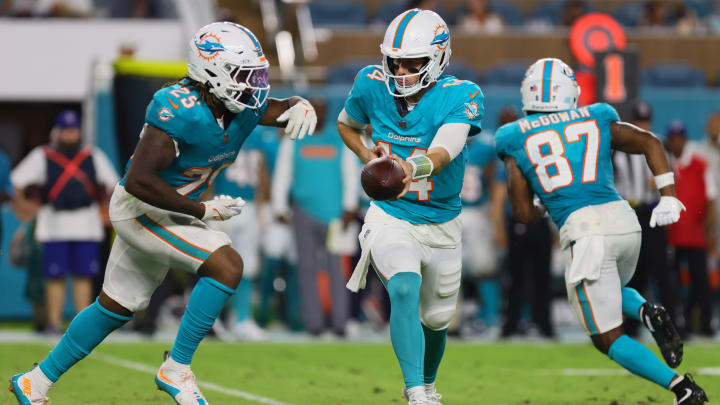 Aug 9, 2024; Miami Gardens, Florida, USA; Miami Dolphins quarterback Mike White (14) hands off the football to running back Jaylen Wright (25) against the Atlanta Falcons during the third quarter at Hard Rock Stadium. Mandatory Credit: Sam Navarro-USA TODAY Sports