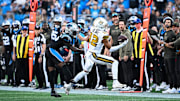 Nov 9, 2025; Charlotte, North Carolina, USA; New Orleans Saints wide receiver Chris Olave (12) makes a one handed catch as Carolina Panthers cornerback Chau Smith-Wade (26) defends during the fourth quarter at Bank of America Stadium. Mandatory Credit: Bob Donnan-Imagn Images