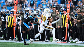 Nov 9, 2025; Charlotte, North Carolina, USA; New Orleans Saints wide receiver Chris Olave (12) makes a one handed catch as Carolina Panthers cornerback Chau Smith-Wade (26) defends during the fourth quarter at Bank of America Stadium. Mandatory Credit: Bob Donnan-Imagn Images